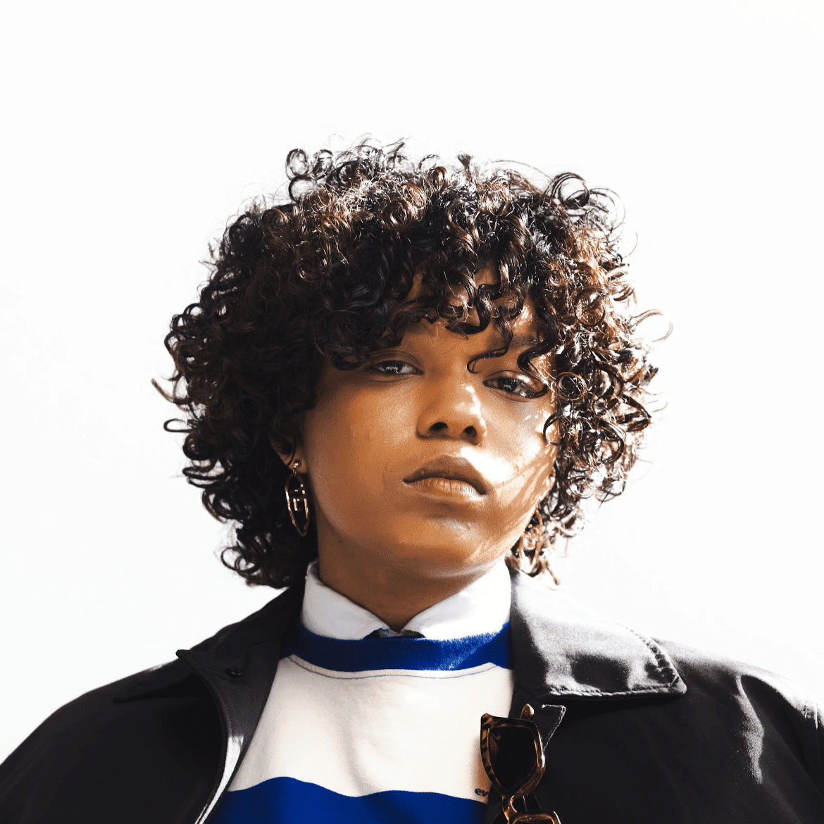 Portrait of Roman Hall, a professional stylist at Salon Wave, showcasing their expertise and style.