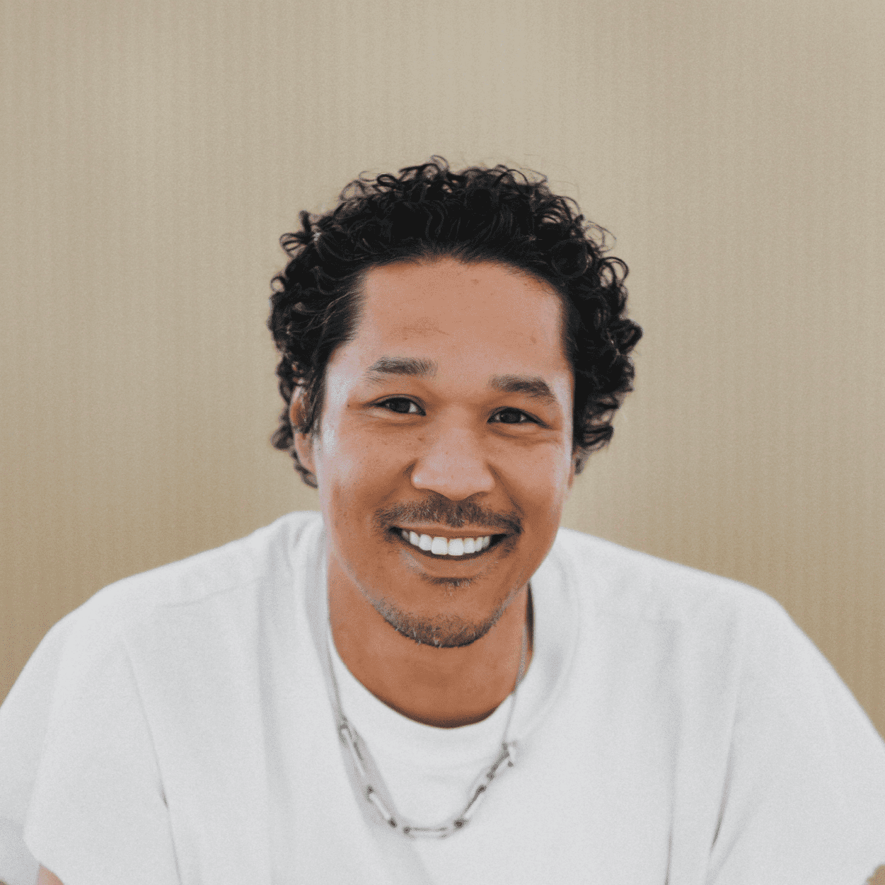 Portrait of Thomas Simpson, a professional stylist at Salon Wave, showcasing their expertise and style.